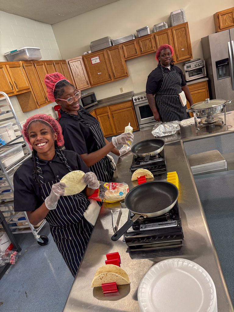 Staff getting lunch served by CTE Students