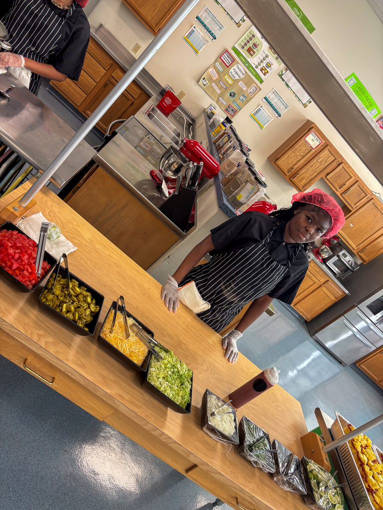 Staff getting lunch served by CTE Students
