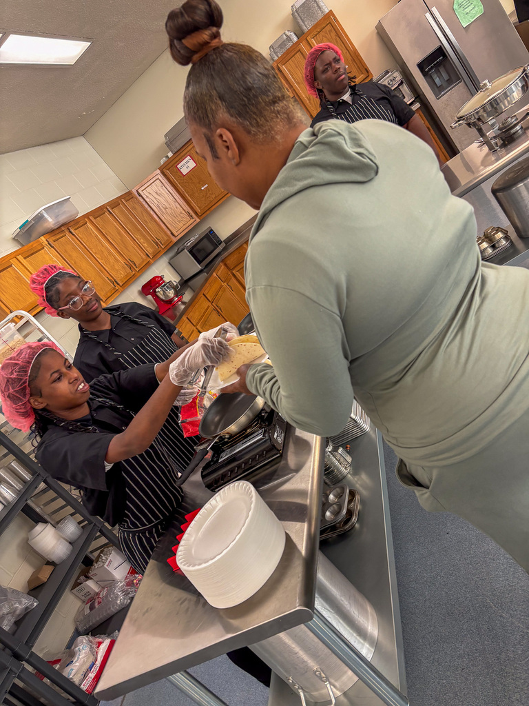 Staff getting lunch served by CTE Students