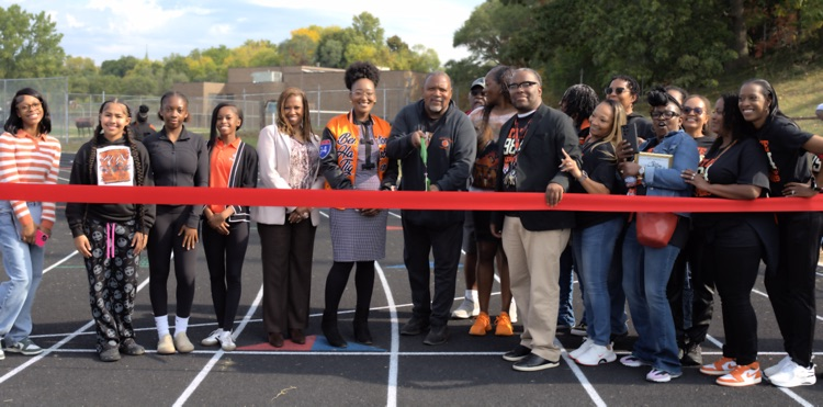 ribbon cutting at BHHS Track with BHAS leaders, track coach, track team and 1984 state champions