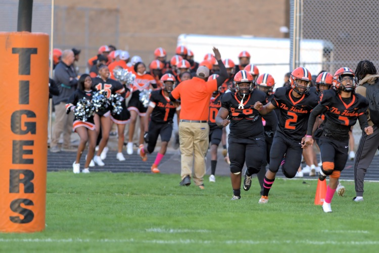 BHHS Football players running onto the field at Homecoming Game