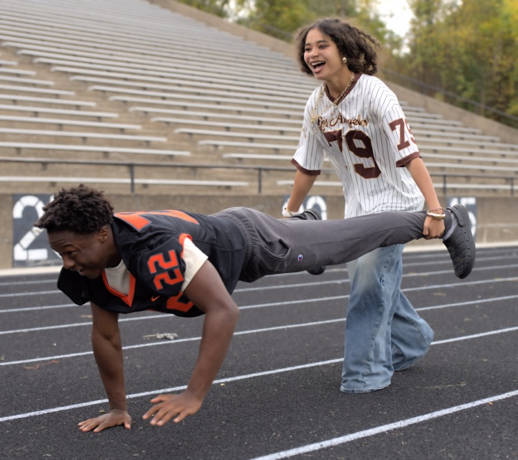 students participating in wheel barrel race at pep rally