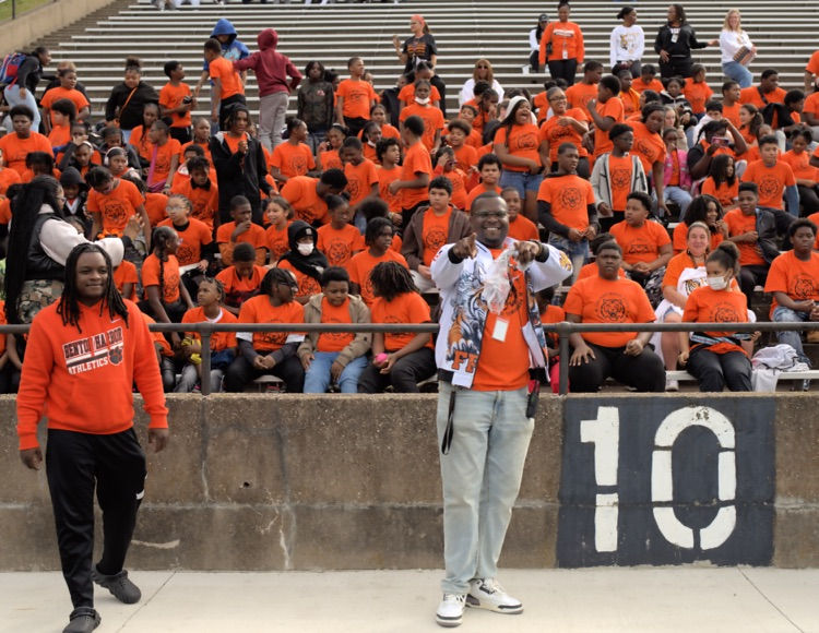 middle school students and principal at homecoming pep rally
