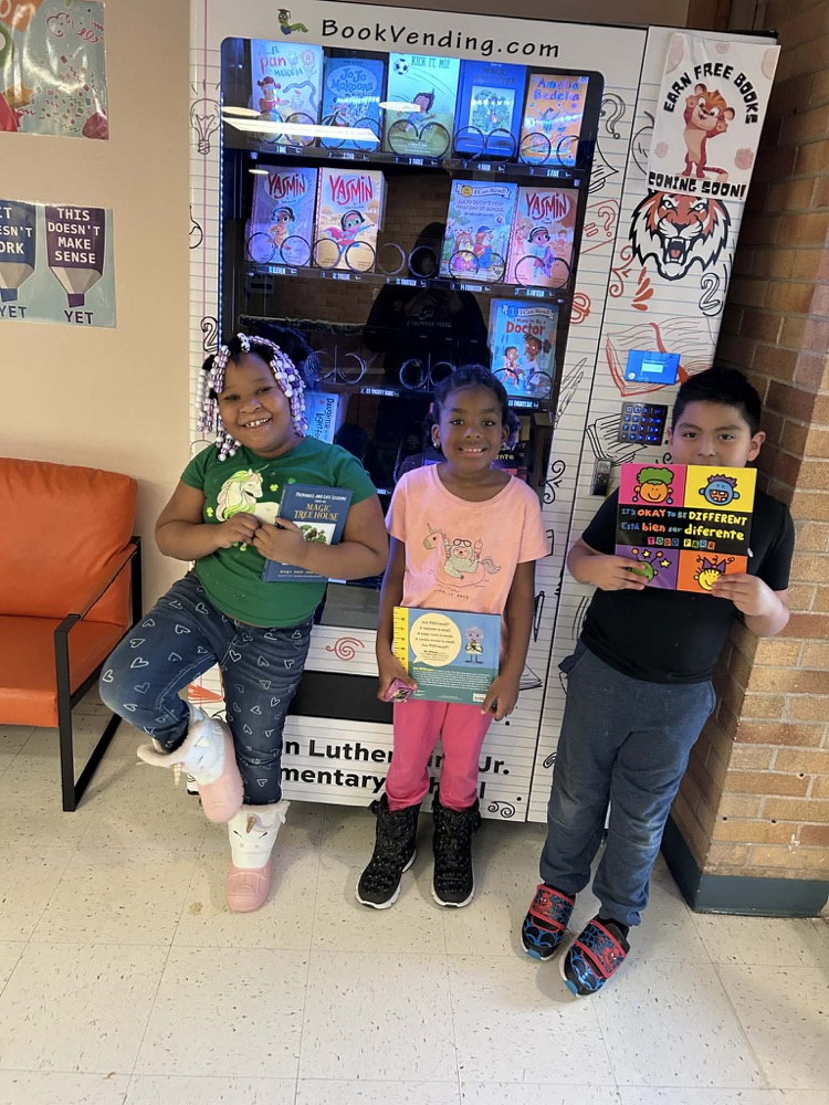 MLKJ students earning a free brand new book for excellent behavior.