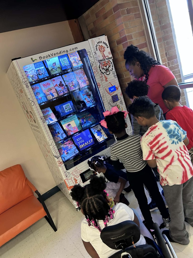 MLKJ students earning a free brand new book for excellent behavior.