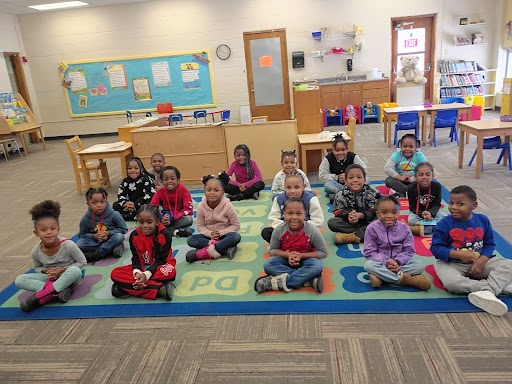 DEC Students smiling on rug