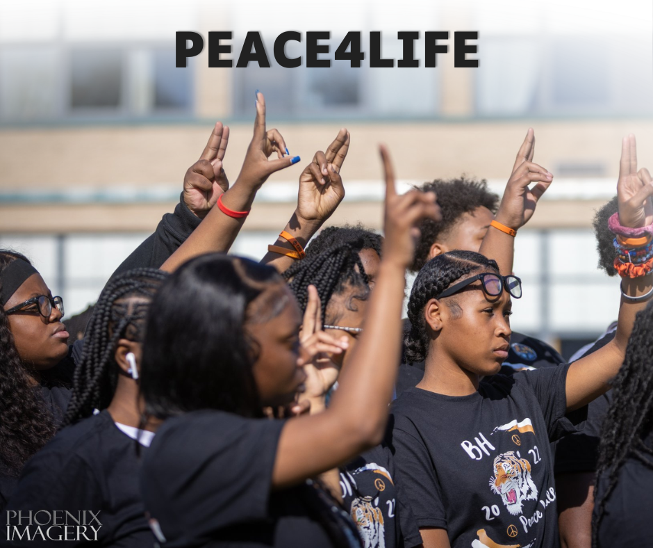 A group of students wearing black Benton Harbor "Peace Life" Tiger T-shirts stand together outdoors with their arms raised, making the peace hand sign. The word "PEACE4LIFE" is printed in bold black letters across the top of the image. The "Phoenix Imagery" watermark is in the bottom left corner.