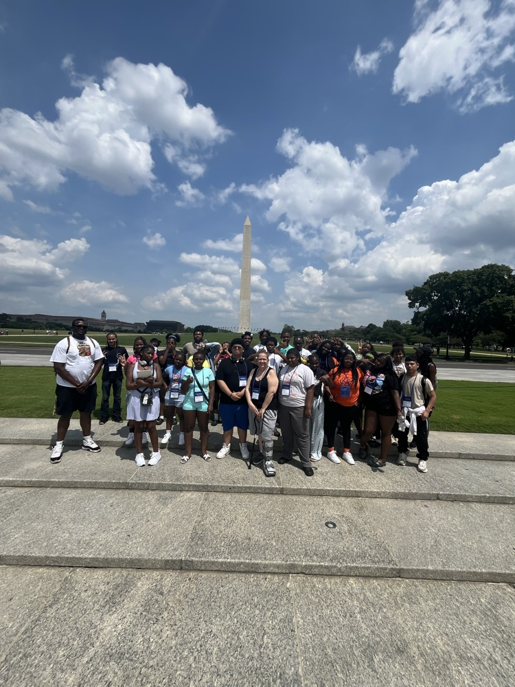 students and staff arriving in front of the Washington monument in Washington DC. 