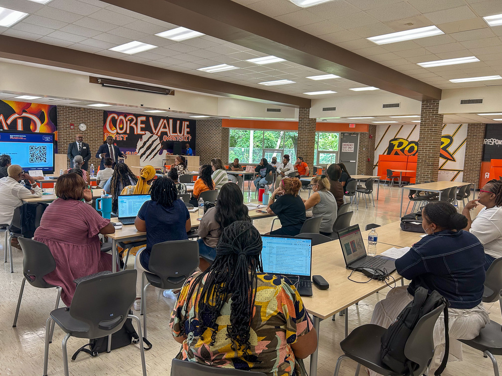 BHAS staff seated at tables listening to presenters during a district professional learning session.