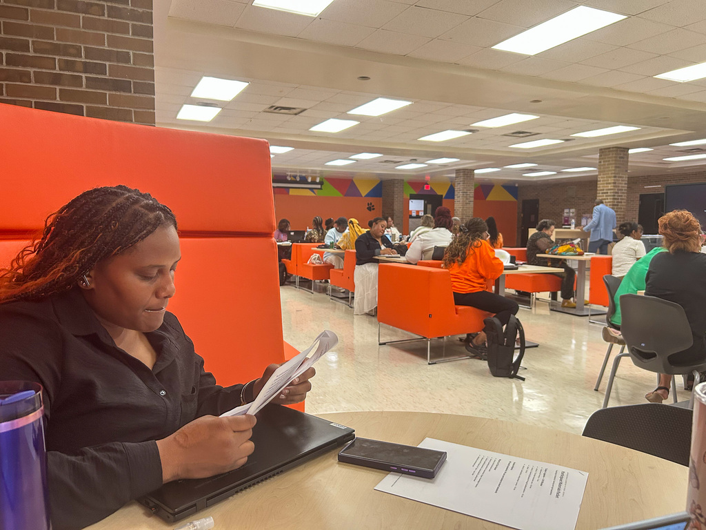 BHAS staff reviewing materials and working in small groups during a professional learning session.