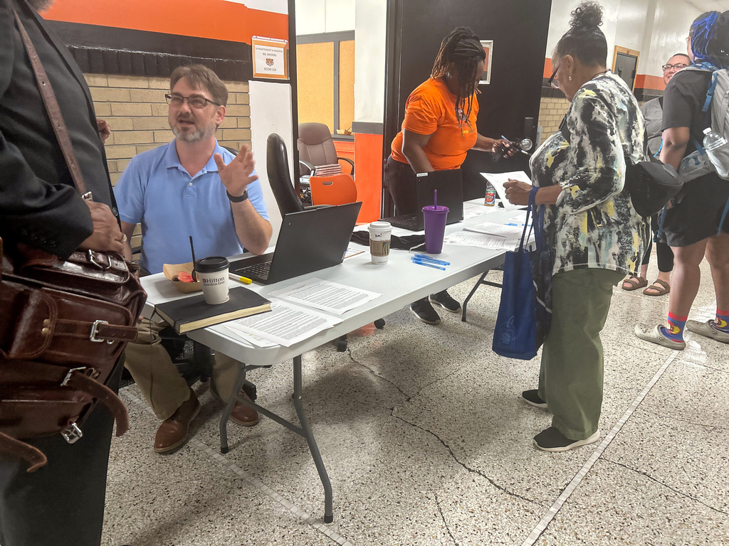 Staff members assisting attendees at a check-in table during a Benton Harbor Area Schools professional learning event.