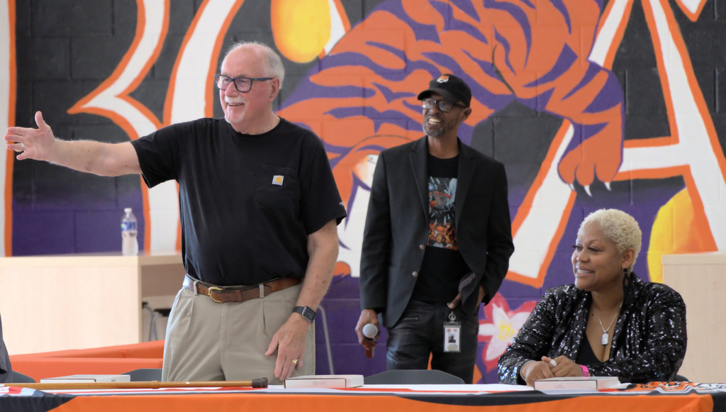 Former Benton Harbor football coach addressing attendees during a playoff team recognition event at the high school.