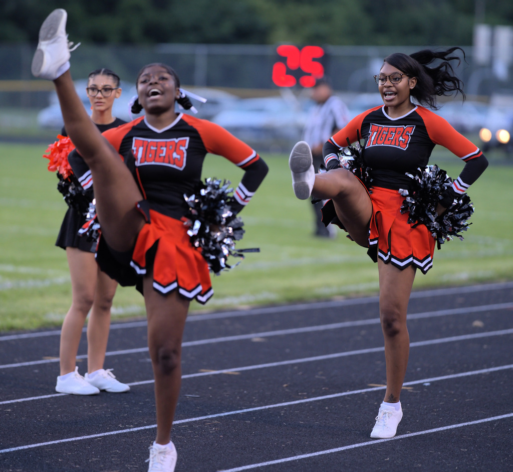 Benton Harbor Tigers cheerleaders performing on the track during the football game.