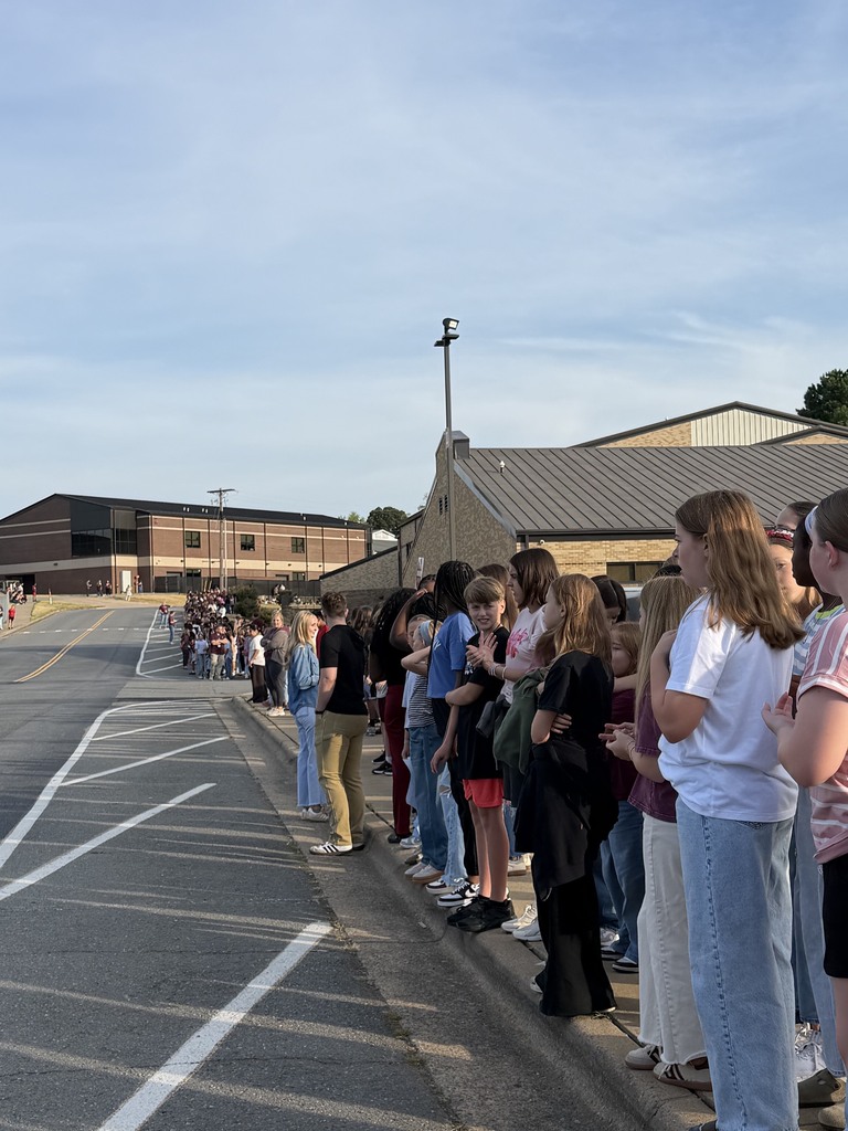 Students from Benton Middle School are lined up along the street waiting patiently for the senior parade to start.