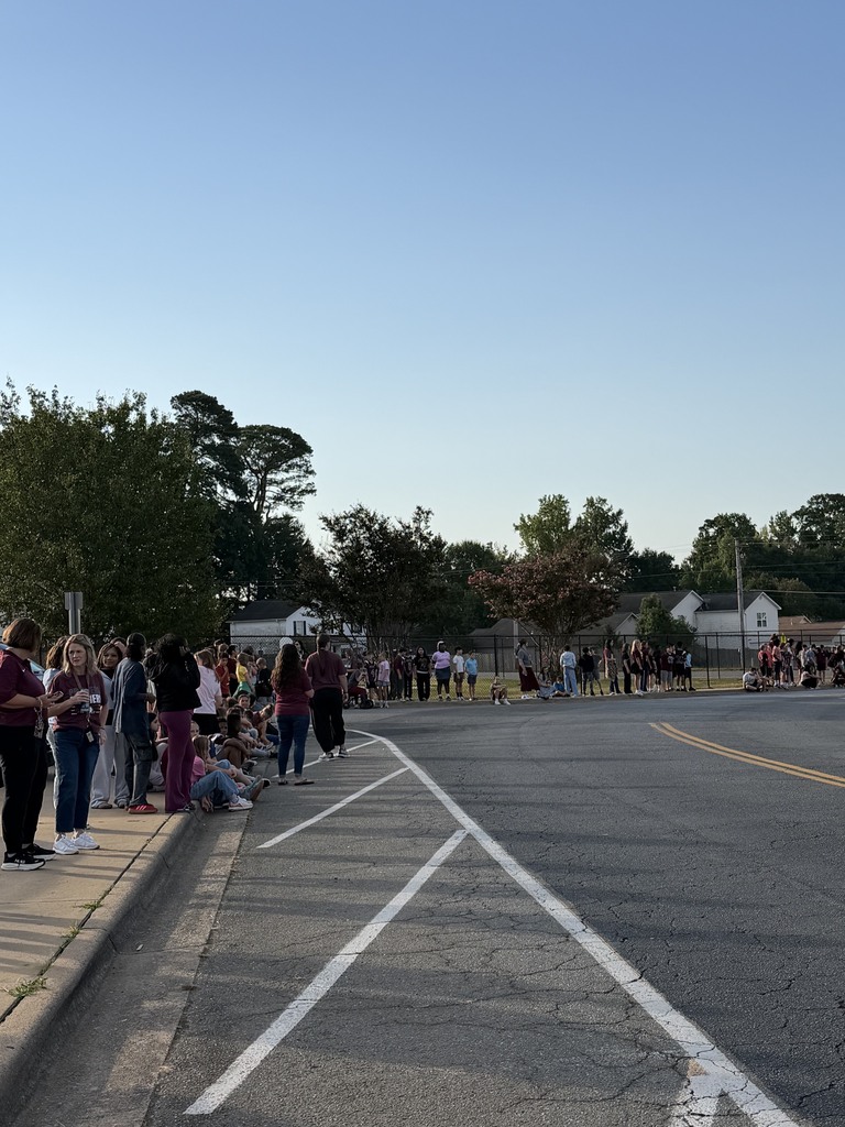 Students from Benton Middle School are lined up along the street waiting patiently for the senior parade to start.