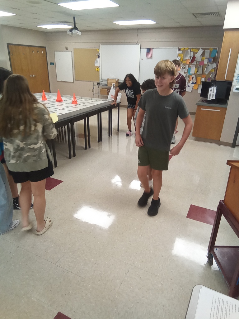 A student walks through the classroom while participating in the activity described in this post.