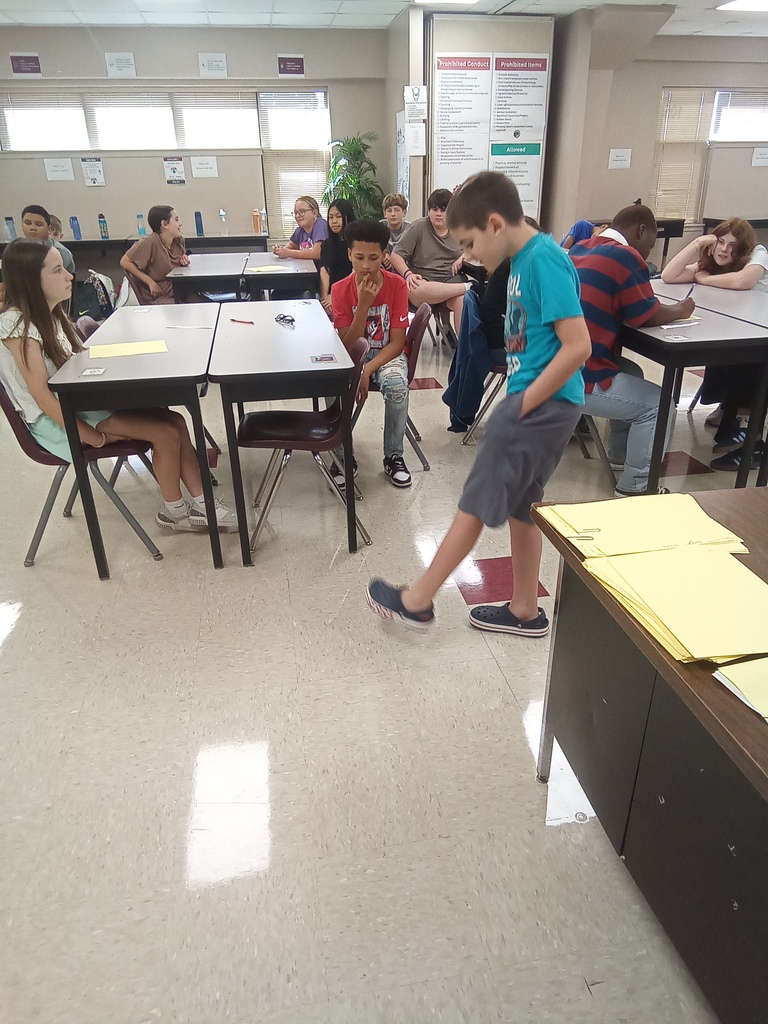 A student is taking careful, precise steps as he participates in the classroom activity.