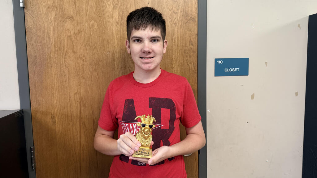 Mrs. Brasel's GOAT of the week poses with his trophy! It is a small golden GOAT that will sit on his desk all week.