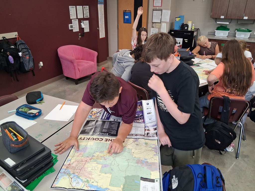 Two students study a map of Benton intently as they attempt to locate landmarks