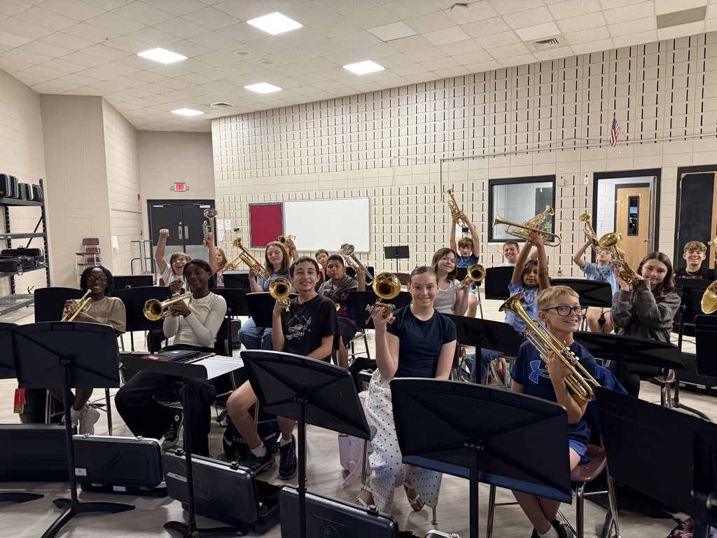 Beginning trumpet and french horn students are learning how to hold instruments for the first time.