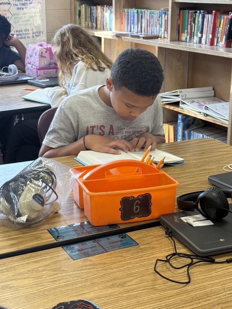 A student is sitting at their table reading the book Wonder in their ELA class