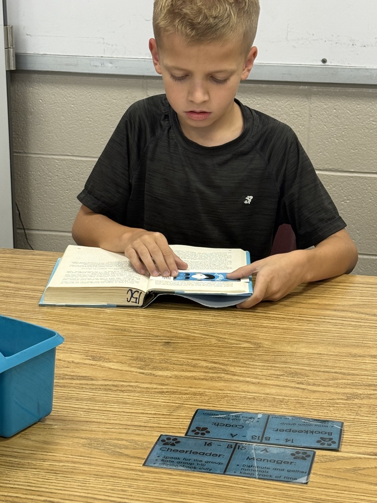 A student is sitting at their table reading the book Wonder in their ELA class