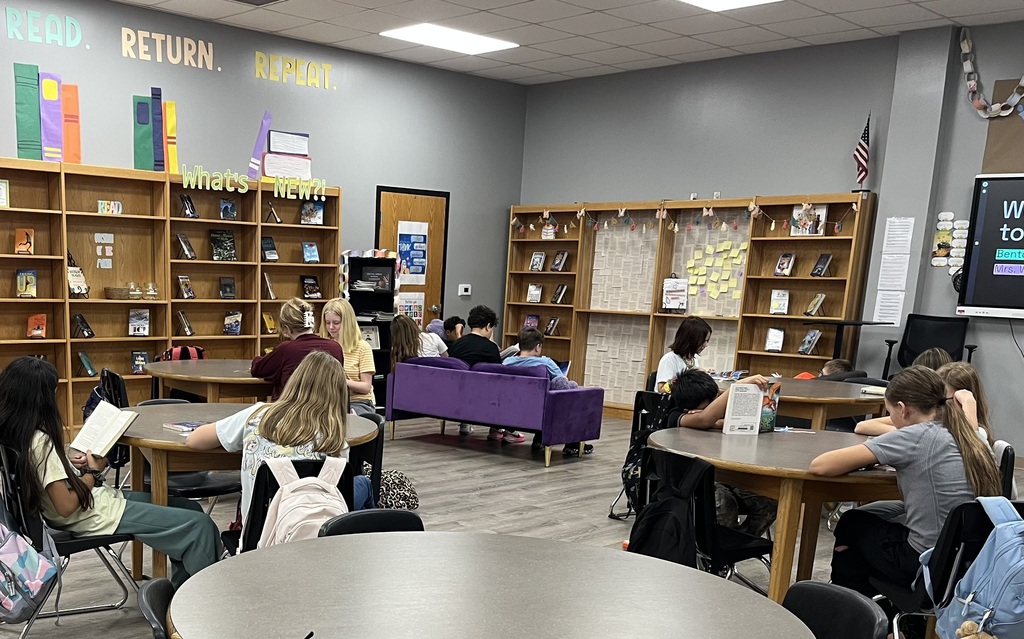 Students in the library are seated around the space reading their first library books of the year.