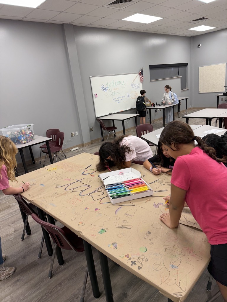 students grouped around making drawings at the doodle table