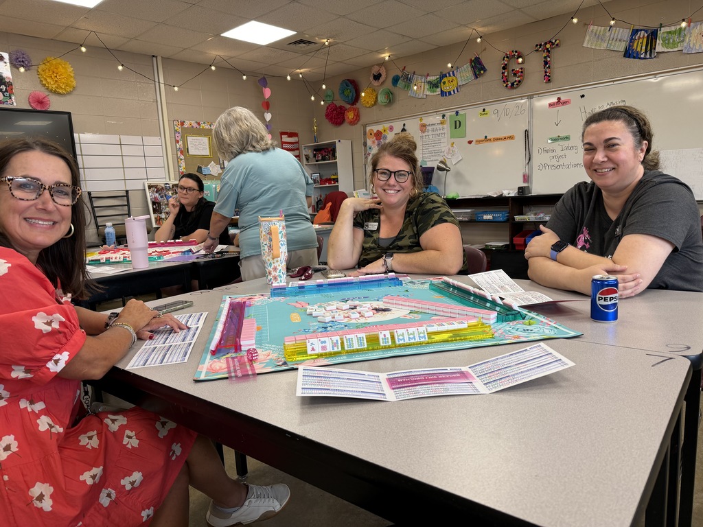 Teachers at BMS smiling for a photo as they partake in the staff Mahjong club meeting