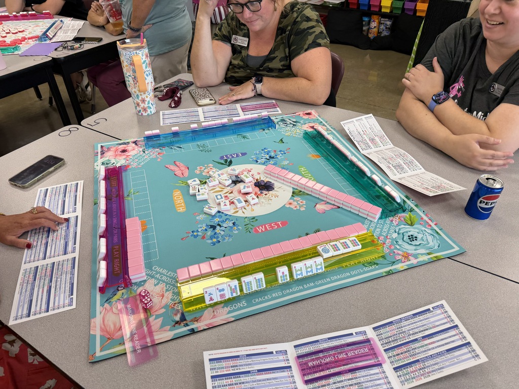 A look at the staff gathered around a game of Mahjong that is currently going