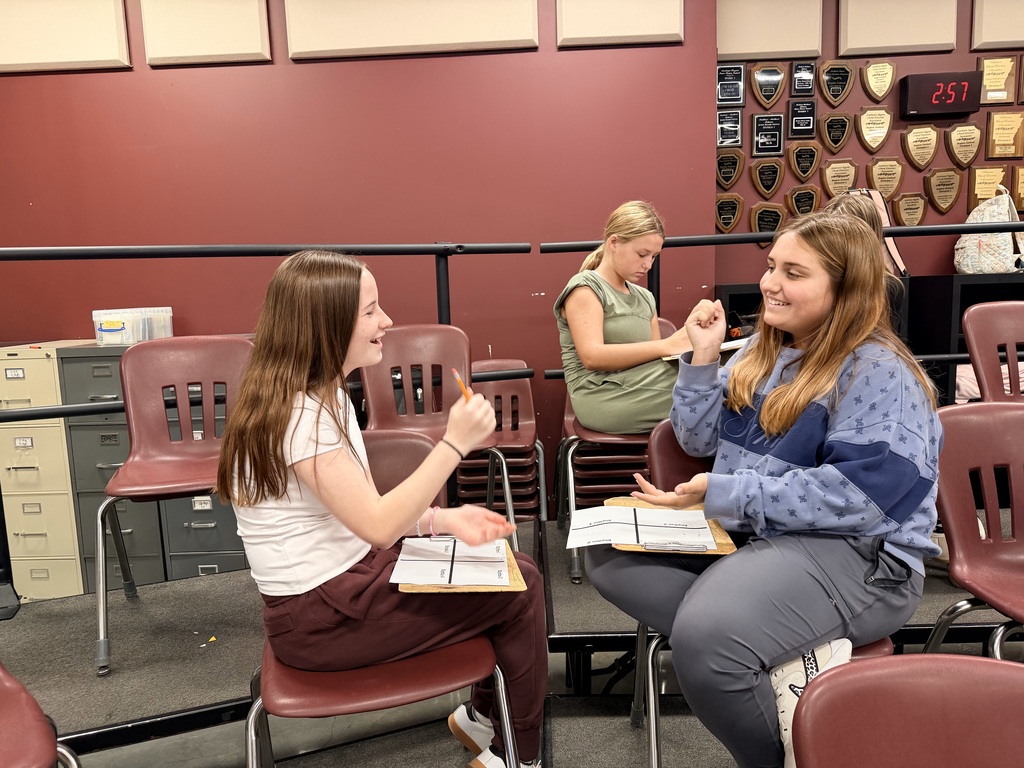 Students around the choir room playing rock, paper, scissors that has been adapted into a rhythm game
