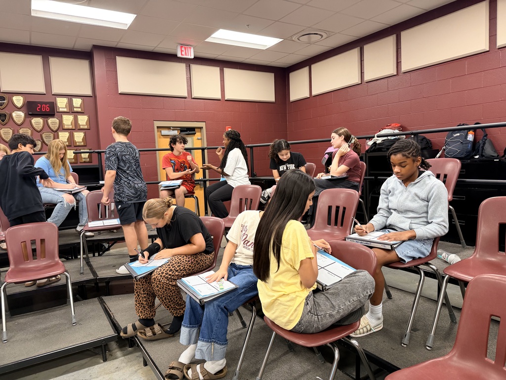 Students around the choir room playing rock, paper, scissors that has been adapted into a rhythm game