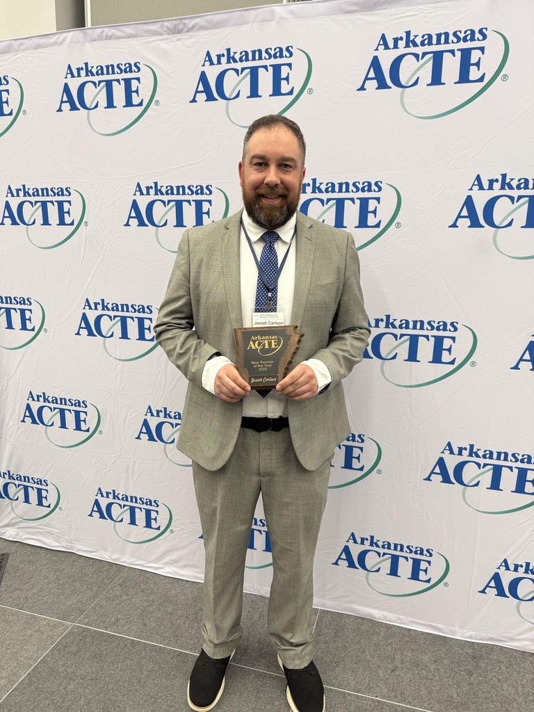 Bentonville West CTE teacher Josiah Carlson poses with his New Teacher of the Year award at the Arkansas ACTE conference.