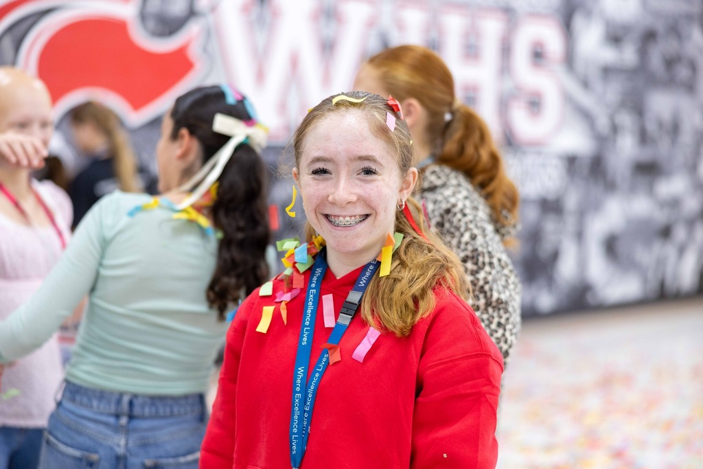 Student smiling with confetti falling
