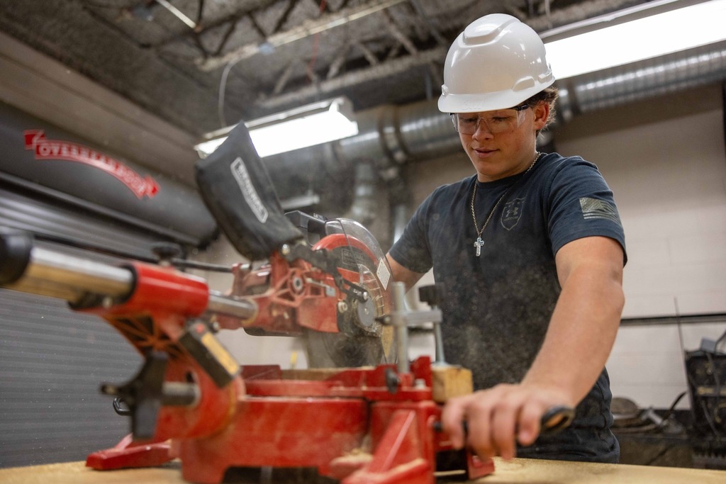 Student working in the construction area of his high school