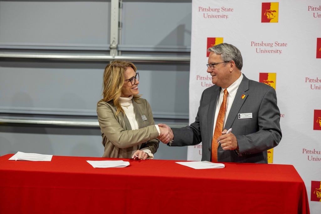 Superintendent Dr. Debbie Jones & Pitt State President Thomas Newsom shaking hands