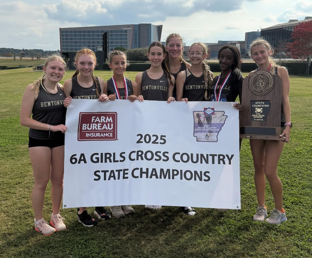 Bentonville High School Women's Cross Country Team Holding the Championship Banner