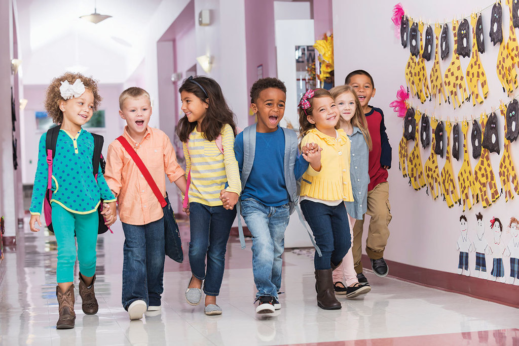 Kindergarten students walking down a hallway