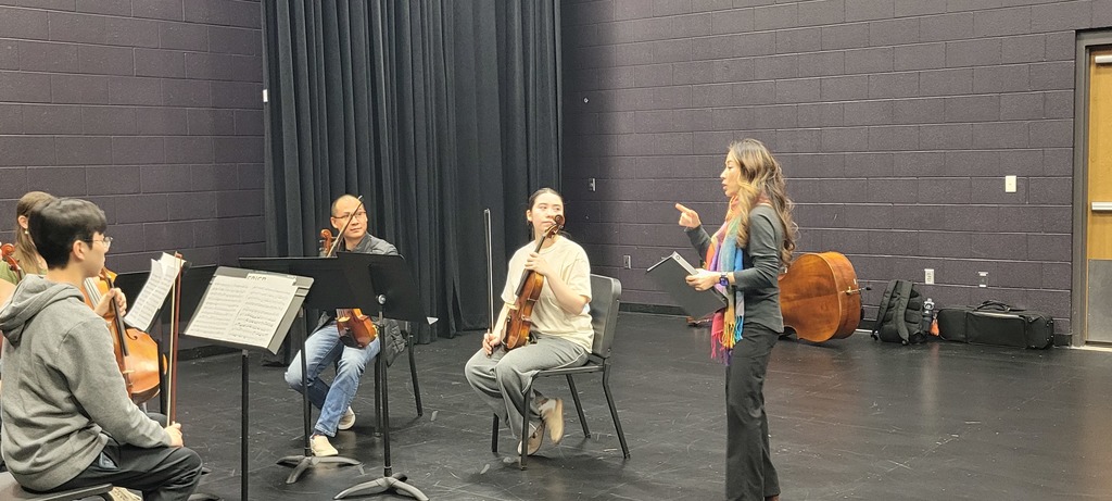 Composer Soon Hee Newbold works with BWHS orchestra students. 
