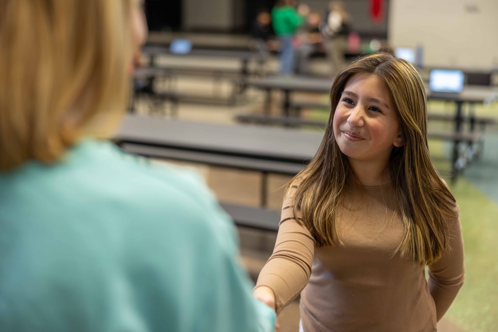 Student shaking hands with a teacher