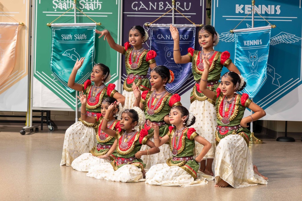 Indian students on stage dressed in traditional attire
