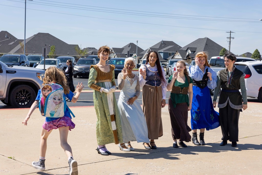Frozen cast waving to elementary students