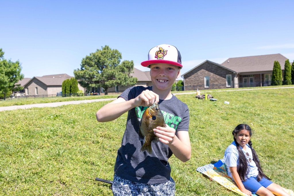 Young student holding a fish