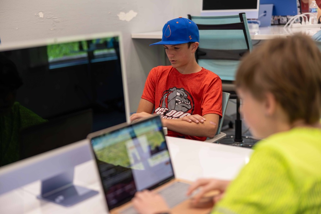 Student studying his laptop at AI Summer Camp