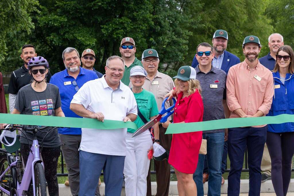 People cutting the ribbon for a new trail