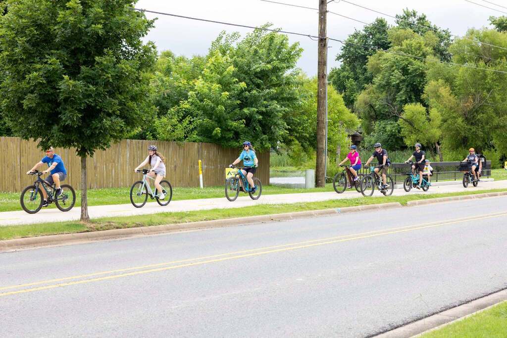 Kids biking down a sidewalk