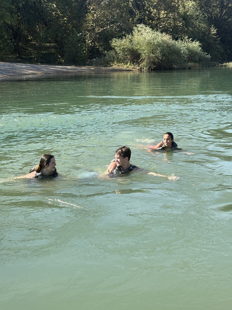 High school students swimming in a local river