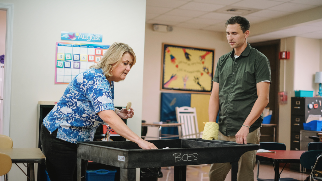 Superintendent delivers a cart of cookies to a teacher in her classroom.