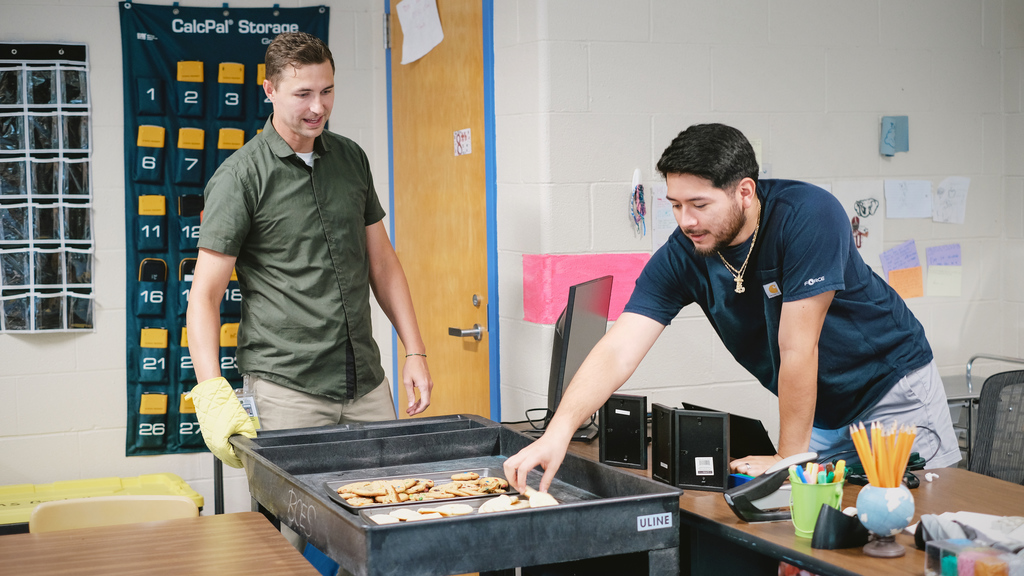 Superintendent delivers a cart of cookies to teachers in their rooms.