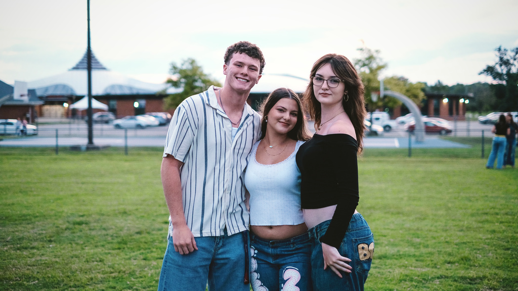 Seniors pose for a photo in front of their high school